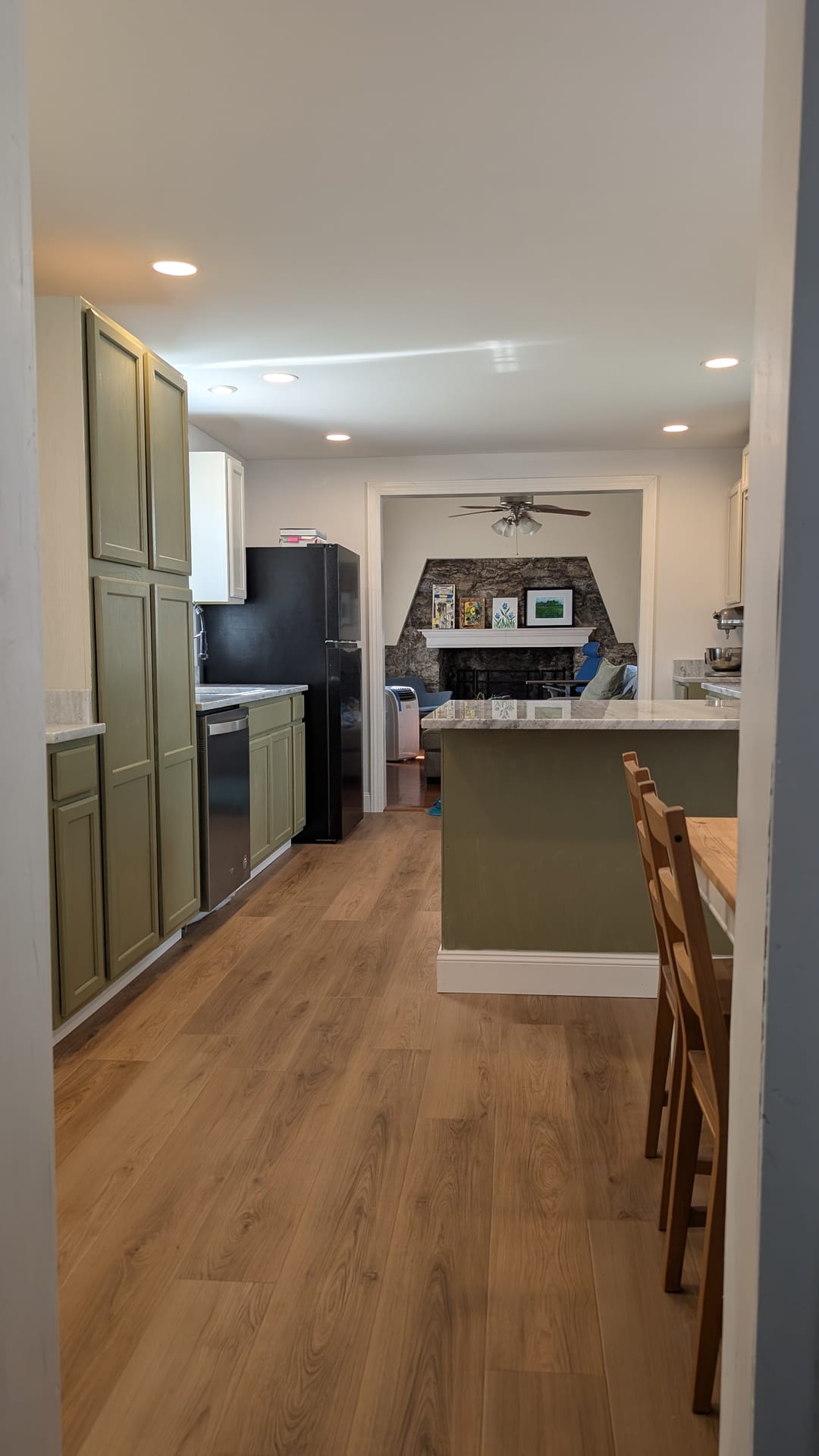 Custom Kitchen Rebuild — Custom fireplace mantel, casing trim, and open-concept kitchen finishes.