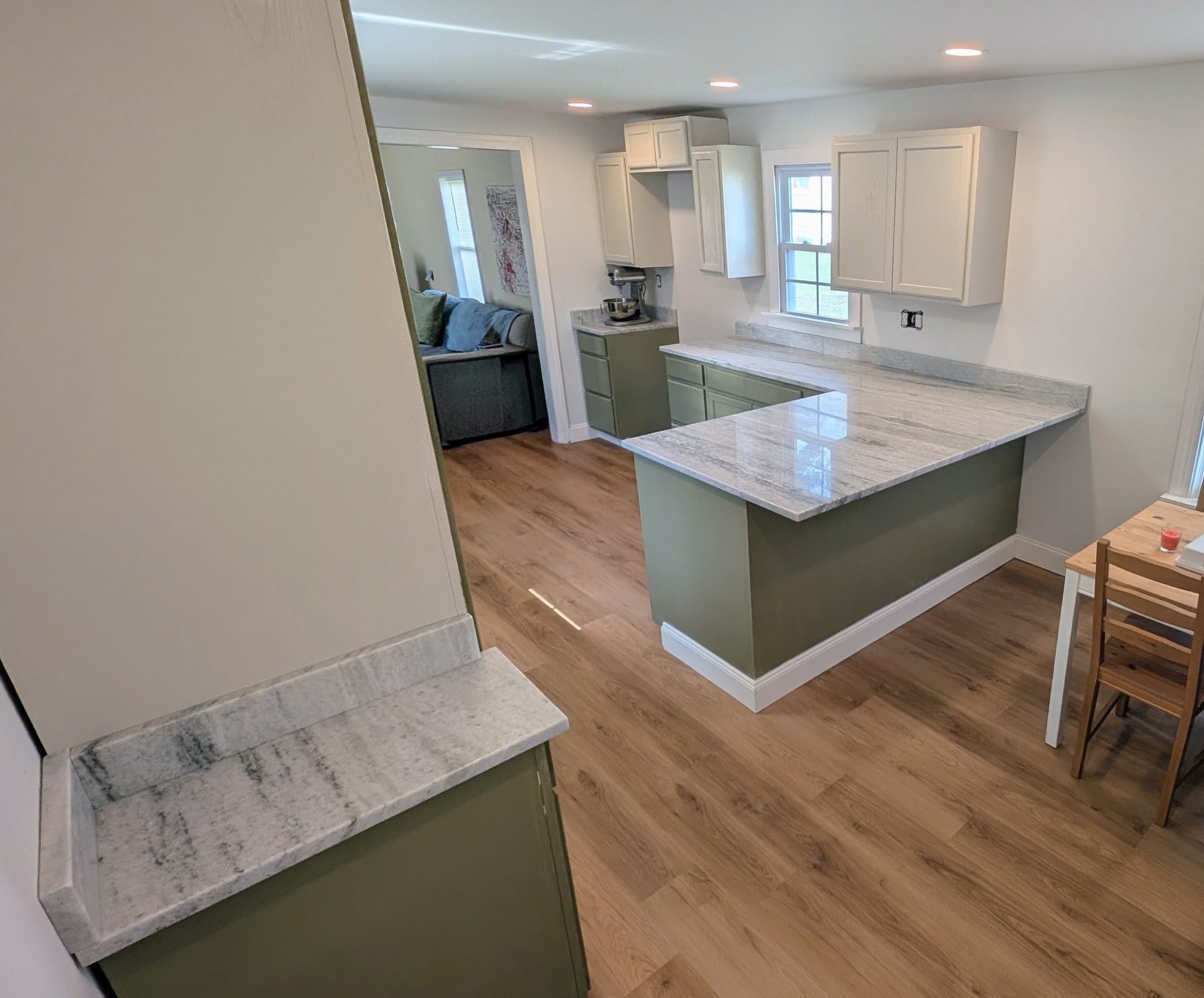 Turnkey Kitchen Reconstruction — Fully restored kitchen space with new cabinetry, quartz surfaces, and flooring.