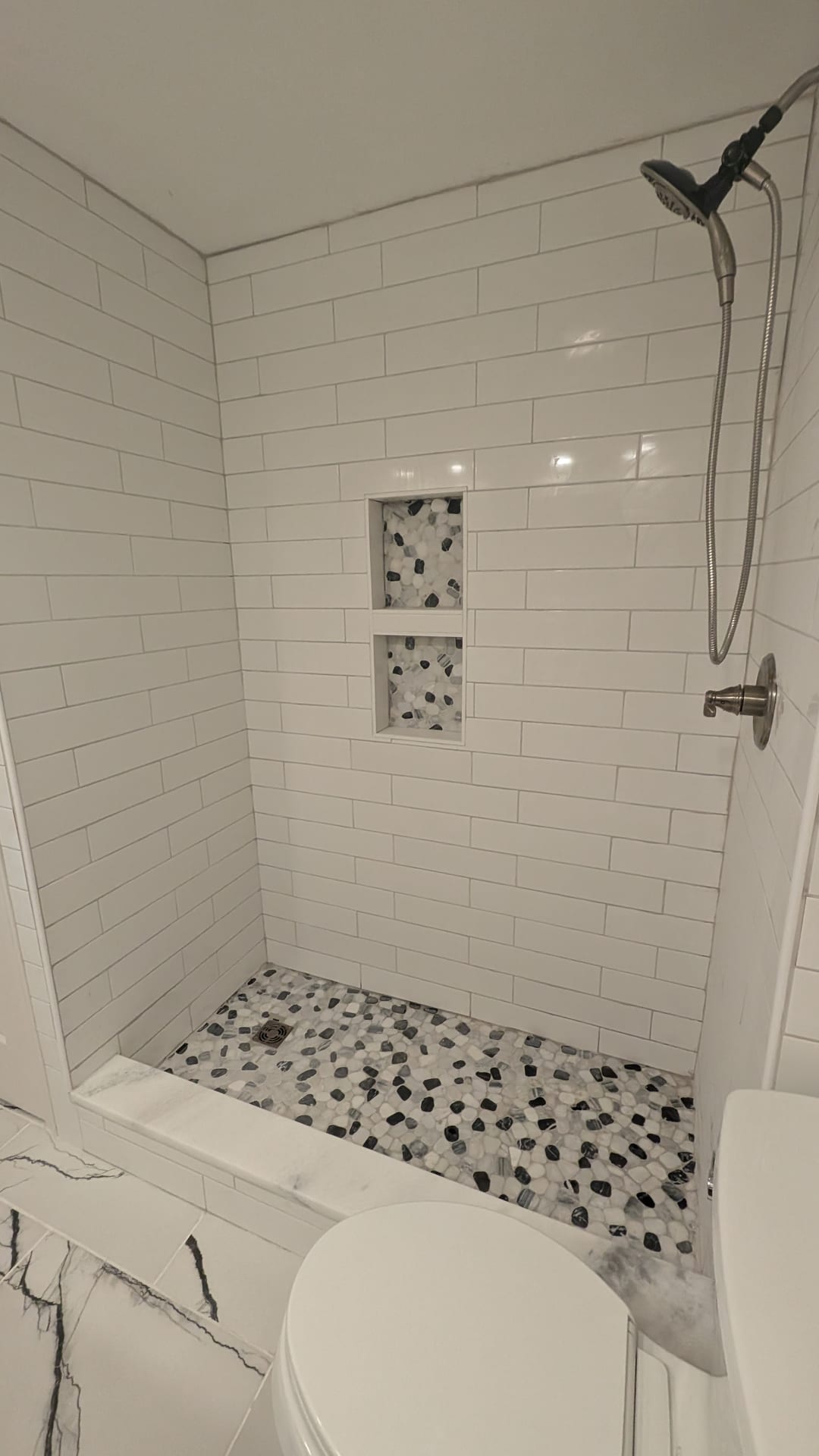 Sub-Grade Bath Shower Rebuild — Finished basement shower built with cementitious backing board and sealed tile.