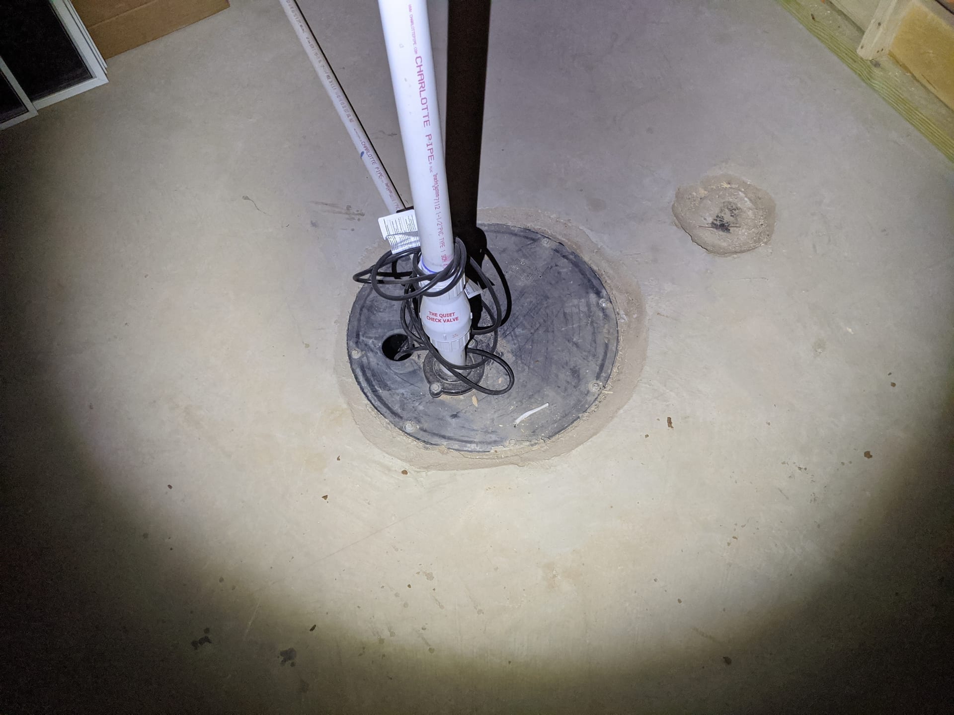 Sump pit and pump inspection in basement foundation