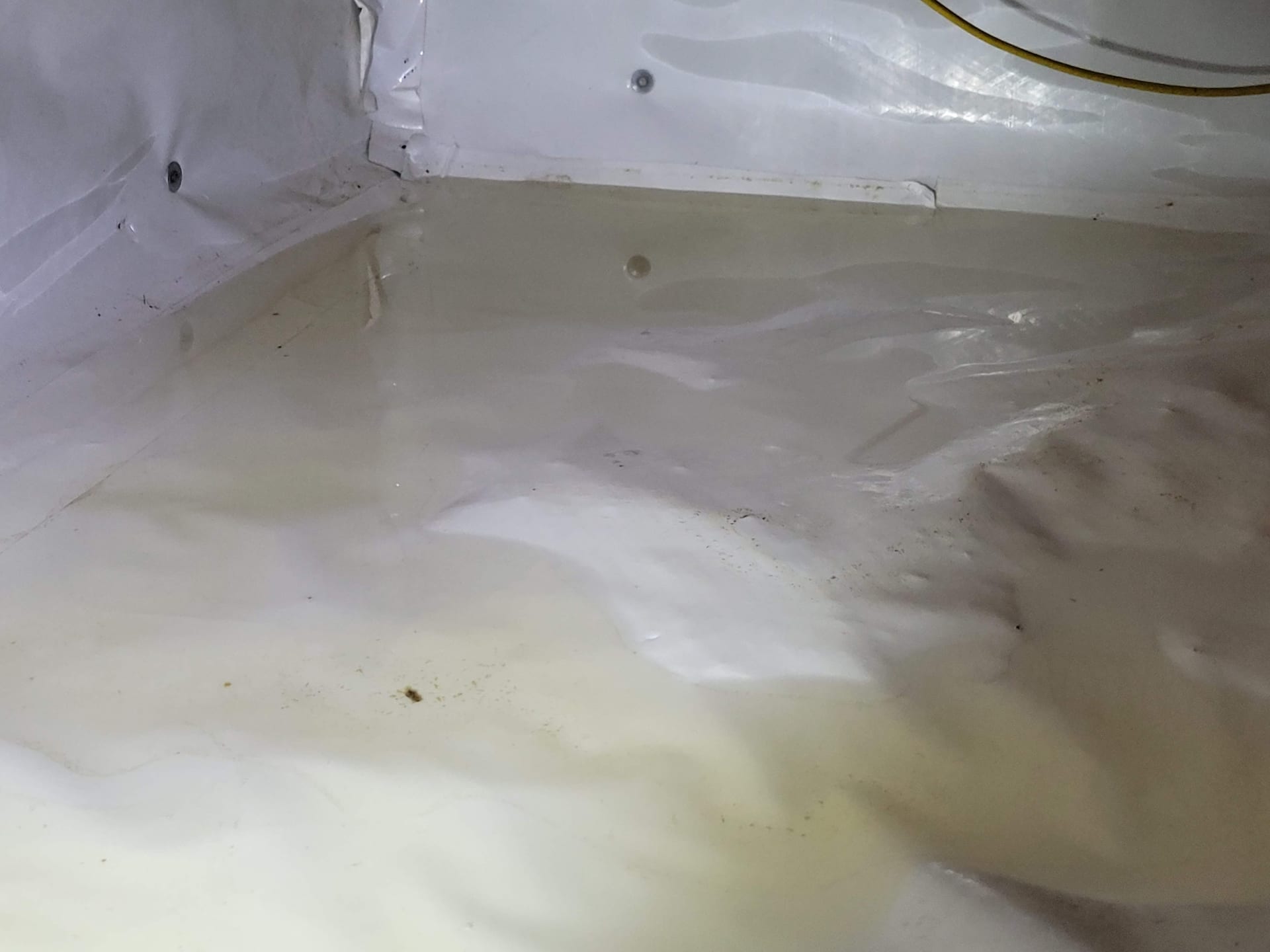 Standing water and damp soil in unsealed crawl space